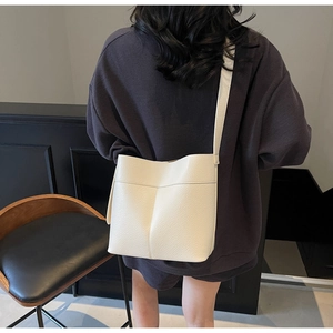 Detail of white lychee pattern leather bucket bag showing texture and stitching