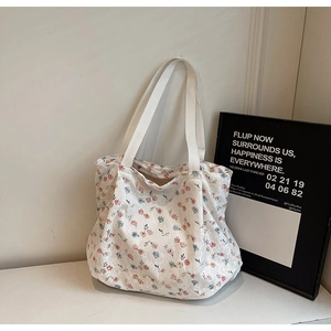Dettaglio ravvicinato della borsa tote in tela a fiori con stampe rosa e blu