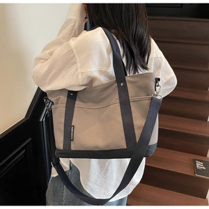Detail view of the durable canvas tote bag featuring adjustable crossbody strap and retro style