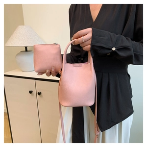 Detailed view of pink pebble leather bucket bag set with matching small zipper pouch
