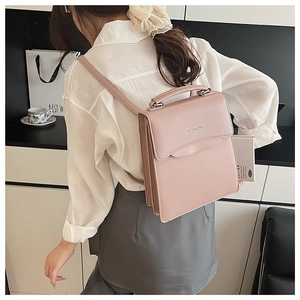 Detail of dusty pink leather handbag with silver Fashion & Bag logo and adjustable strap