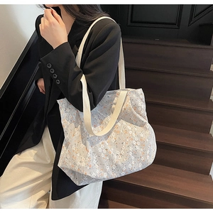 Detailed close-up of floral embroidery on a large capacity lace tote bag for women