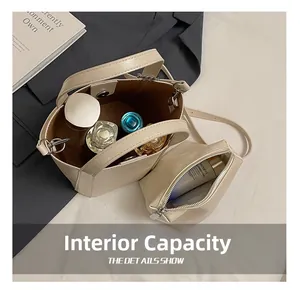 Top view of cream bucket bag showing spacious interior with extra zipper pouch for cosmetics