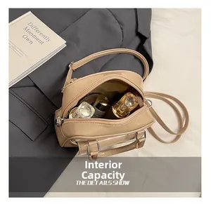 Top-down view of a glossy beige handbag interior showing cosmetics and spacious storage