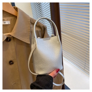 Close-up of silver pebble grain bucket bag showing high-quality metallic leather texture
