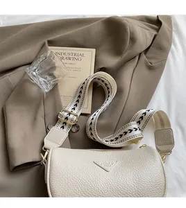 Detail of lychee pattern leather shoulder bag with chic black and white wide strap