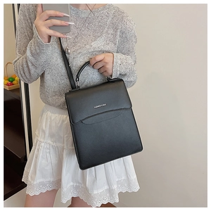 Fashion & Bag black leather crossbody bag with top handle worn as a stylish shoulder bag