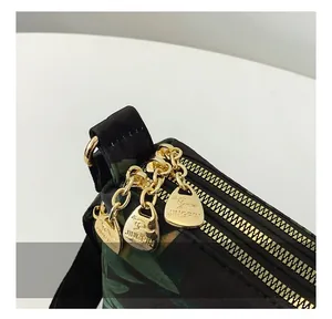 Detail of waterproof nylon bag showing high-quality gold zippers and leaf pattern