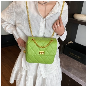 Detail of lime green quilted chain bag with gold metal clasp and diamond stitching