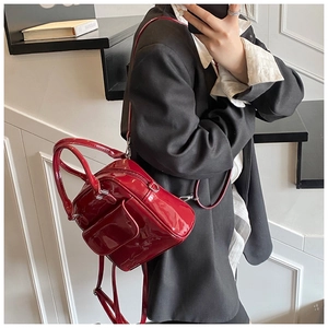 Macro view of red patent leather texture and metallic zipper on this stylish backpack