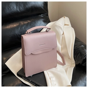 Close-up of pink rectangular tote bag with FASHION & BAG logo on a textured sofa