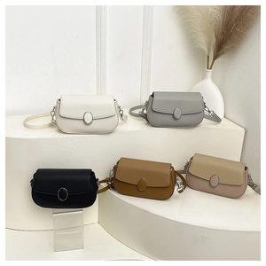 Group of minimalist faux leather saddle bags in five chic colors on a white pedestal