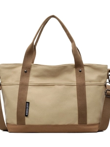 Minimalist beige canvas tote bag with brown straps shown in a centered front view