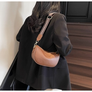 Rear view of brown litchi leather pillow bag with stylish wide patterned shoulder strap