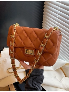 Caramel quilted shoulder bag with gold chain strap and metallic turn-lock closure