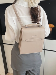 Chic beige structured faux leather backpack with top handle and sleek shoulder straps
