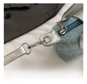 Detail showing premium silver hooks and denim fabric with rhinestones on a handbag