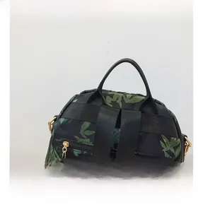 Close-up of leaf pattern backpack showing padded top handle and reinforced straps