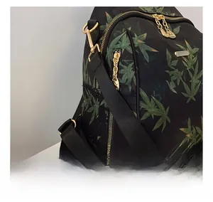 Detail of comfortable shoulder strap connection and gold zippers on floral backpack