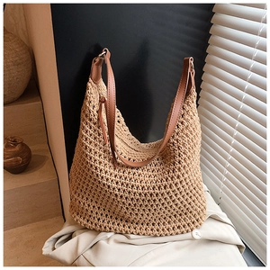 Detail of hollow crochet texture on beige tote bag with premium brown leather strap