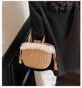 Detail of handmade straw tote bag with delicate lace trim and colorful beads shown on model