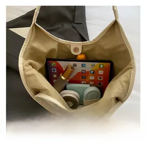 Detail showing the large interior capacity of this cream bucket bag with magnetic closure