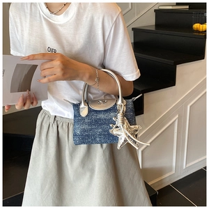 Blue denim mini handbag with silver handle and metallic starfish charm detail