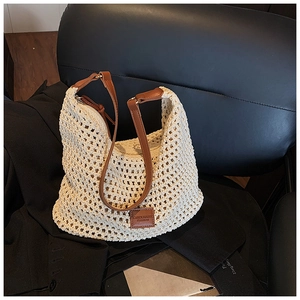Detailed macro view of beige hollow-out crochet pattern and premium brown leather trim