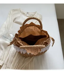 Close-up of internal compartment in straw bag with lace trim and drawstring liner