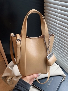 Fashionable beige PU leather bucket handbag with small pouch and adjustable shoulder strap