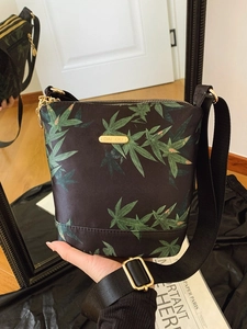 Waterproof nylon crossbody bag with green leaf pattern and adjustable strap