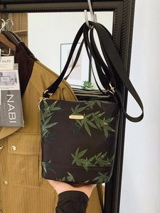 Waterproof nylon crossbody bag with green leaf pattern and adjustable wide strap
