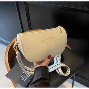 Detail of off-white lychee grain leather crossbody bag with geometric wide strap