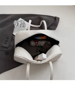 Top view of white pebble leather bag showing spacious interior with daily essentials
