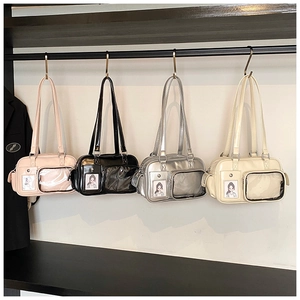 Detail of four versatile colorful shoulder bags with transparent PVC front pockets
