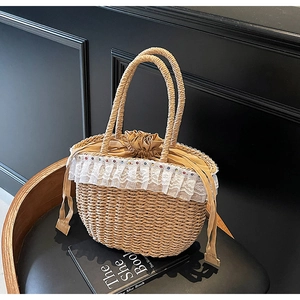 Close-up of woven straw bag with white lace trim, colorful beads, and drawstring lining