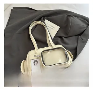 Detail showing the transparent display window and card slot of a beige faux leather bag
