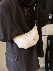 Chic off-white croissant shoulder bag featuring a stylish stitched leather crescent design