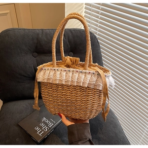 Detail of handmade straw tote bag featuring white lace trim and colorful bead accents