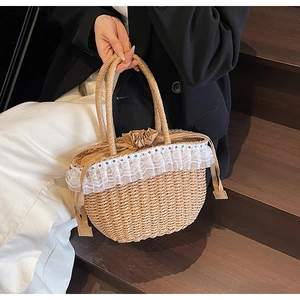 Close-up of bohemian straw handbag featuring delicate lace trim and colorful beaded accents