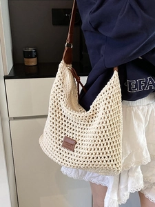 Beige crochet hobo bag with brown leather straps and woven mesh texture for women