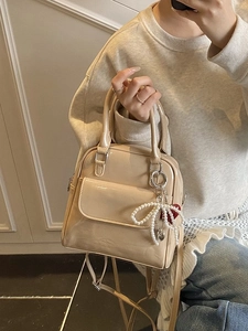 Chic beige patent leather convertible backpack with pearl bow and red heart charms