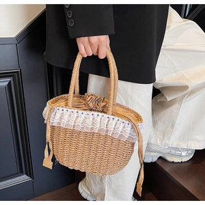 Detail of straw woven bag with white lace trim, colorful beads and drawstring lining