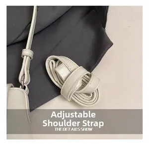 Close-up of adjustable white PU leather strap with silver metal buckle detail