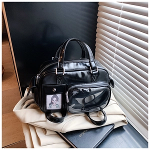 Detail of black glossy PU leather Boston bag with transparent window and cartoon card pocket