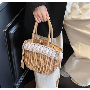 Detail of hand-woven straw bag featuring delicate white lace trim and colorful bead accents