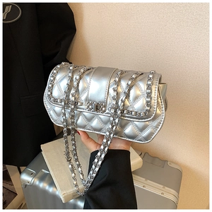 Close-up of silver quilted crossbody bag with metallic finish and chain strap