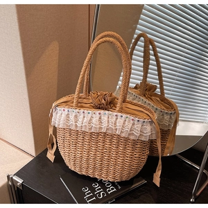 Detailed close-up of beige straw bag featuring white lace trim and colorful dot accents