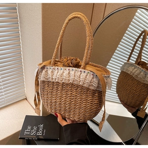 Detailed view of woven straw bag featuring delicate lace trim and colorful bead accents