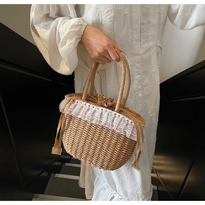 Detail of straw woven handbag featuring white lace trim and colorful beaded accents